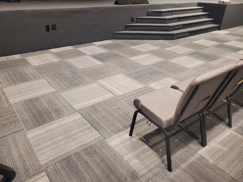 Auditorium carpet tile near the stage, cleaned