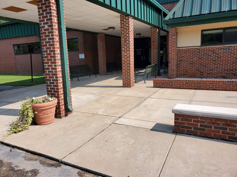 Freshly pressure-washed school entrance and concrete walkway in Upstate South Carolina